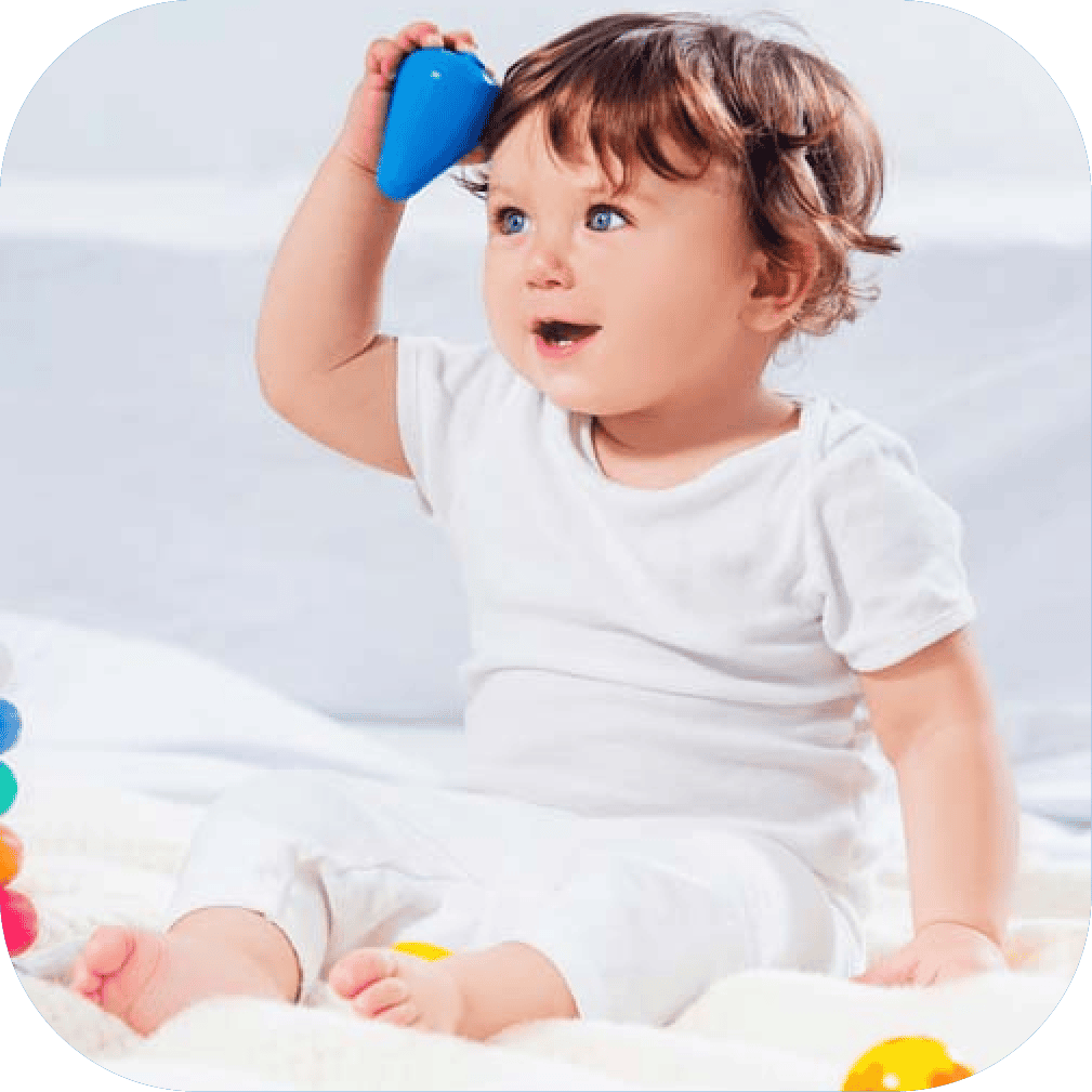 Bright young child playing with colourful toys, developing early communication and speech skills in a supportive learning environment.