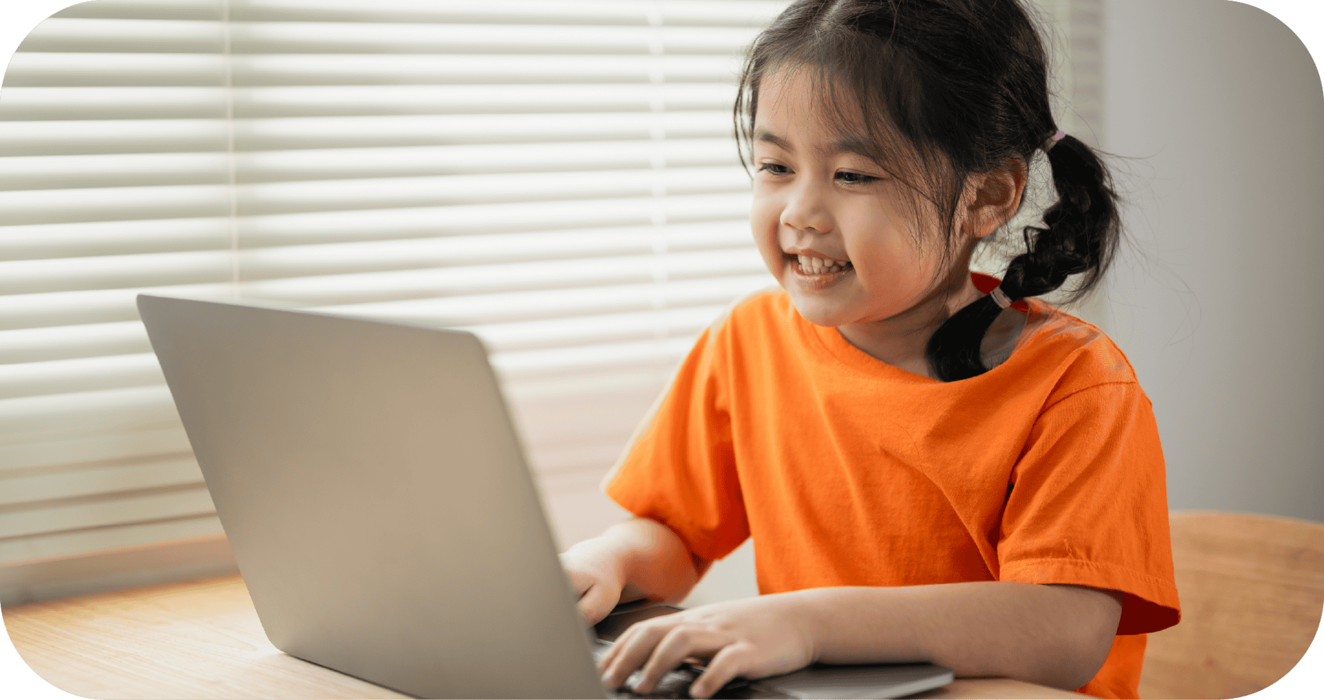 Engaging young girl using a laptop for speech therapy, showcasing child speech development and virtual speech therapy services from Chatterbox Speech, Australia.