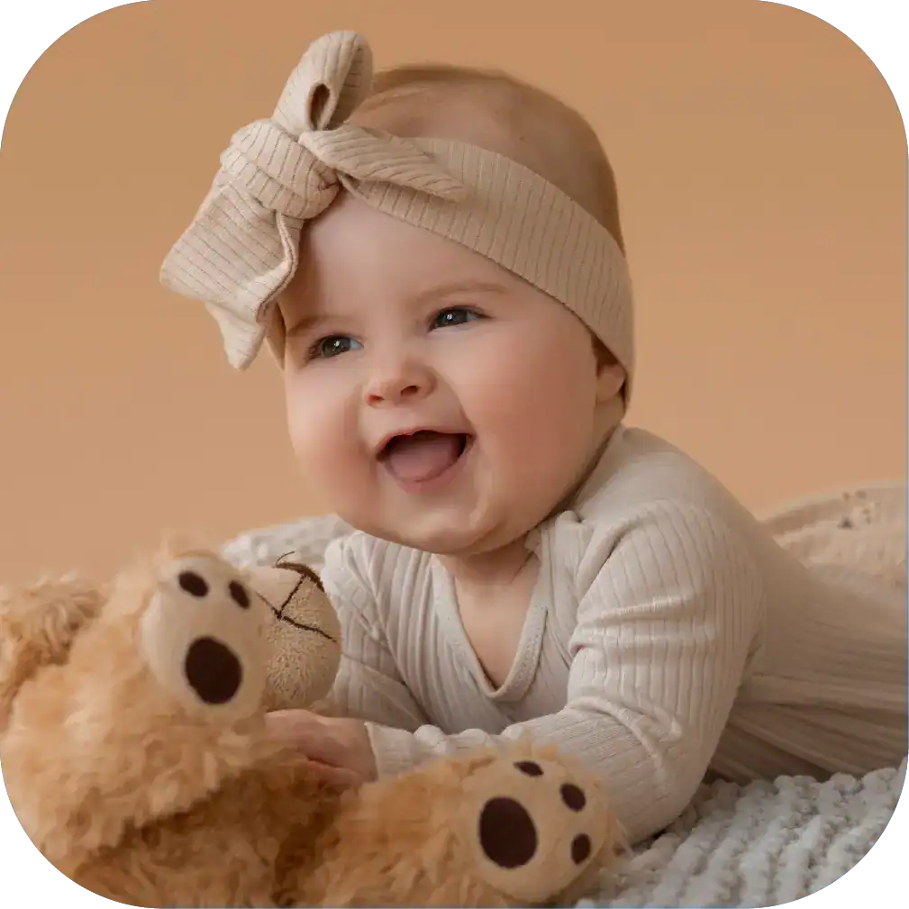 Vibrant baby with a beige headband and bow, engaging in speech therapy activities with a plush teddy bear, promoting early childhood communication and speech development.