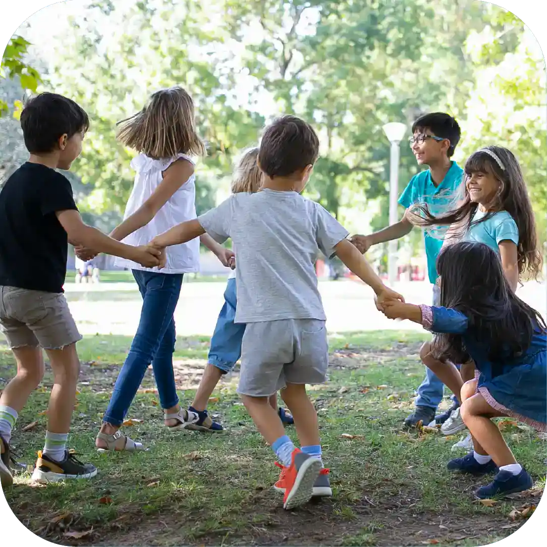 Children playing outdoor circle game in park, developing social skills and teamwork, fun play activity for kids, healthy outdoor recreation for children.