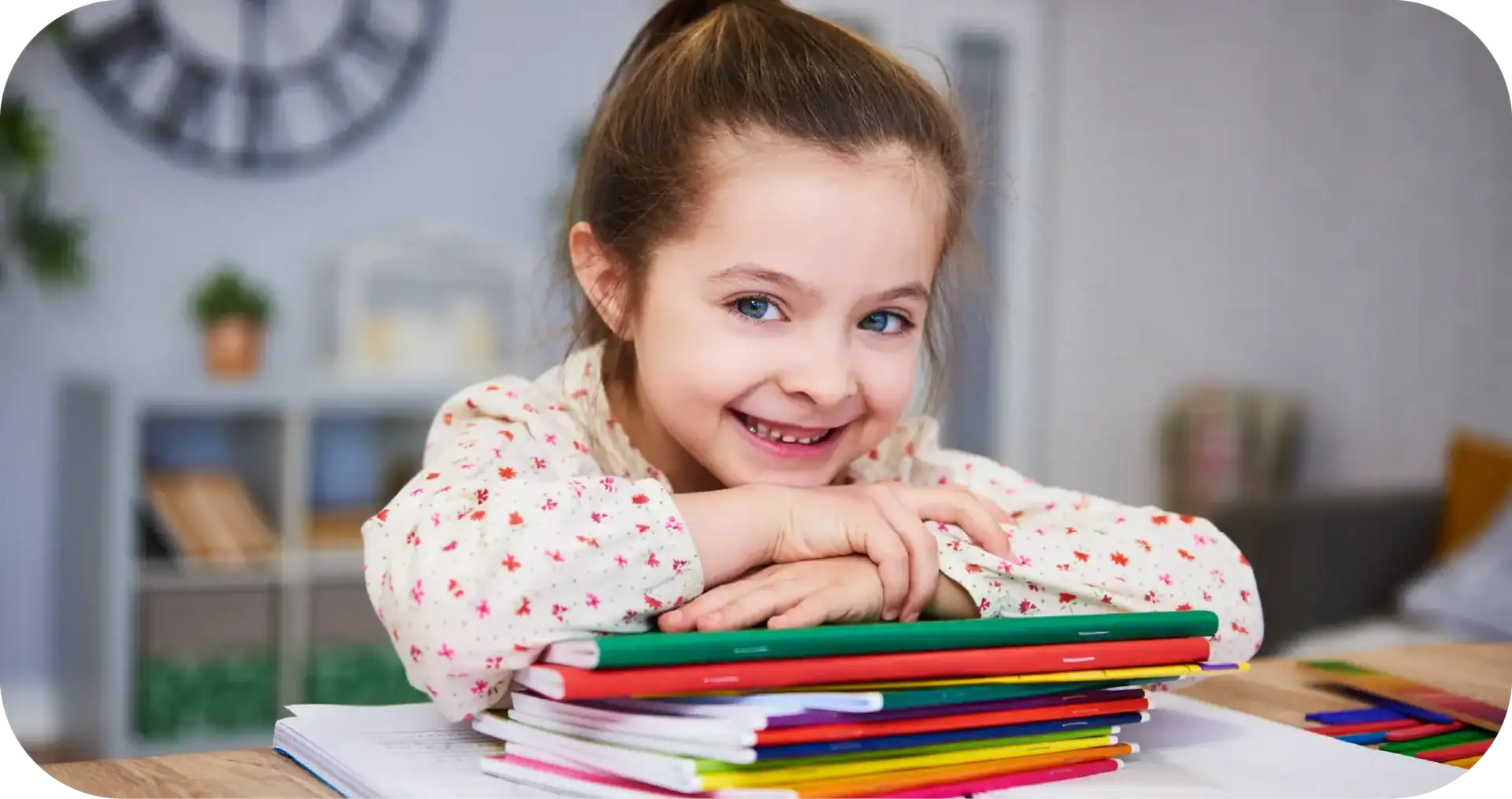 Bright smiling young girl with blue eyes and brown hair, engaging in speech development activities at home.