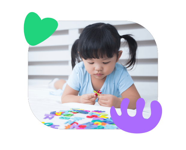 Bright young girl developing speech and language skills with colourful alphabet puzzles, supporting early communication and learning at Chatterbox Speech.