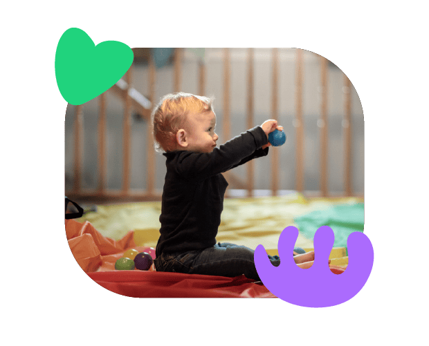Bright toddler engaging with colorful toys in a developmental play area, promoting speech and language skills for early childhood communication.