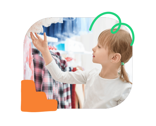 Colourful young girl selecting clothes at a store, promoting speech therapy and communication skills development through playful learning.