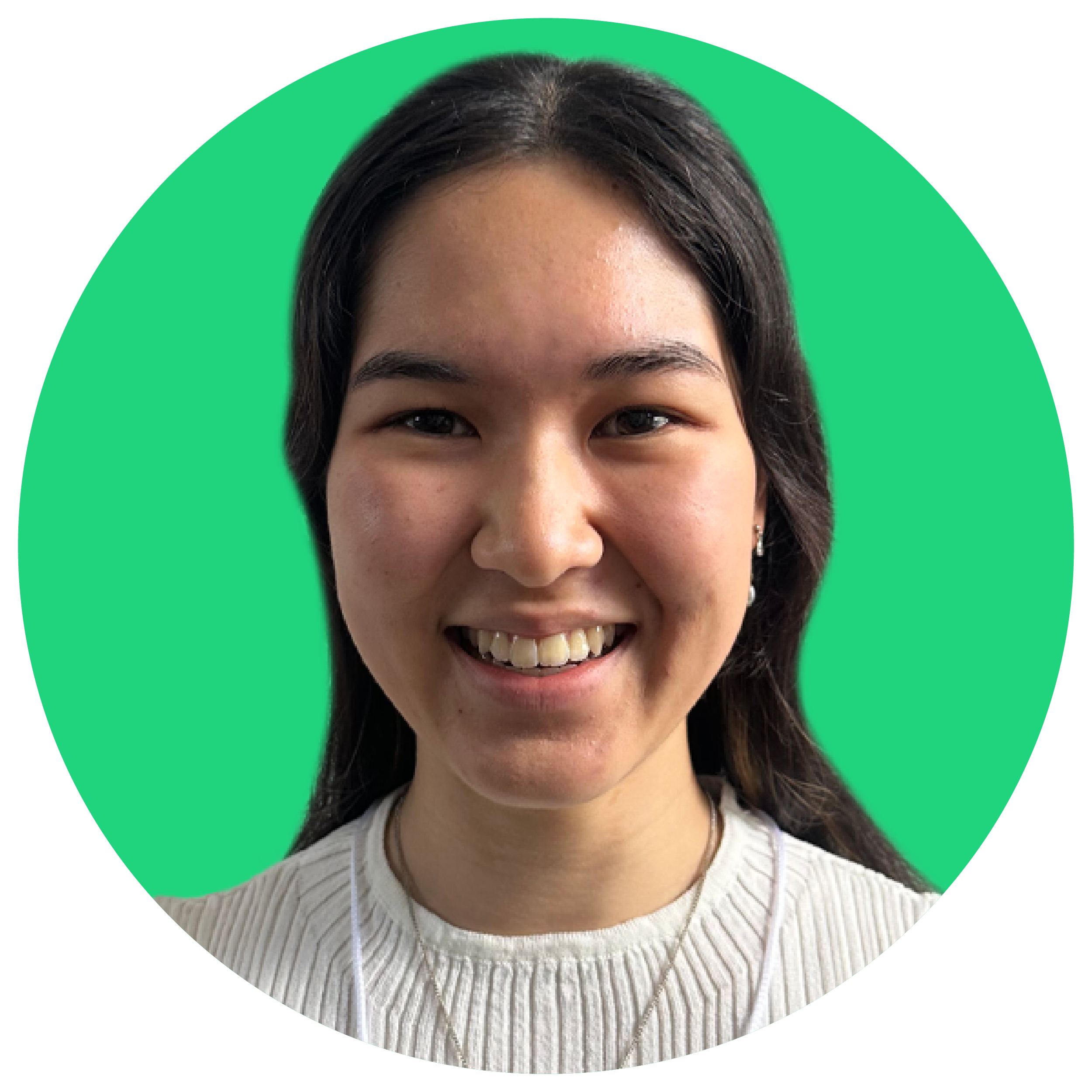 Smiling young girl with long dark hair in front of a green background, representing speech and communication skills for Chatterbox Speech.