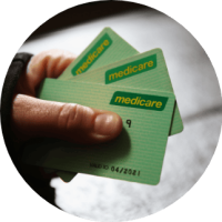 Medicare and Medicare cards held in hand, representing healthcare services and government health coverage in Australia.